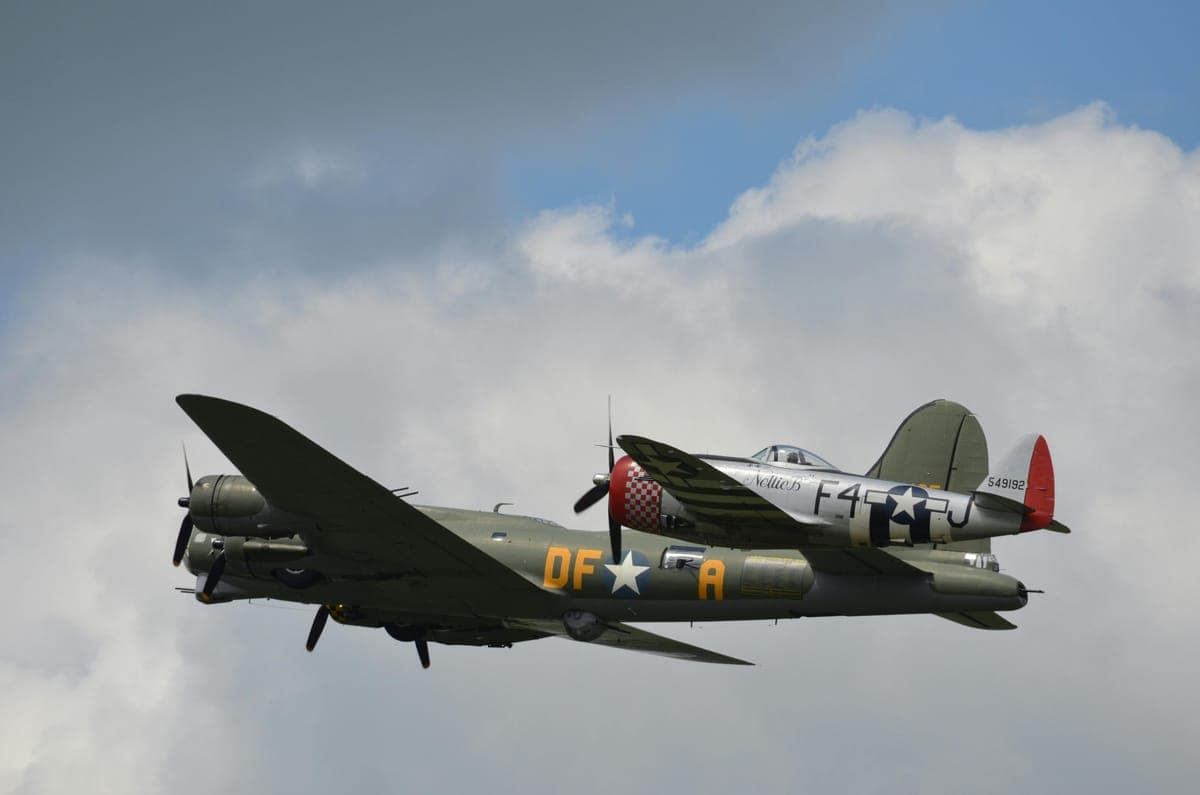 A Second World War bomber and fighter plane flying together