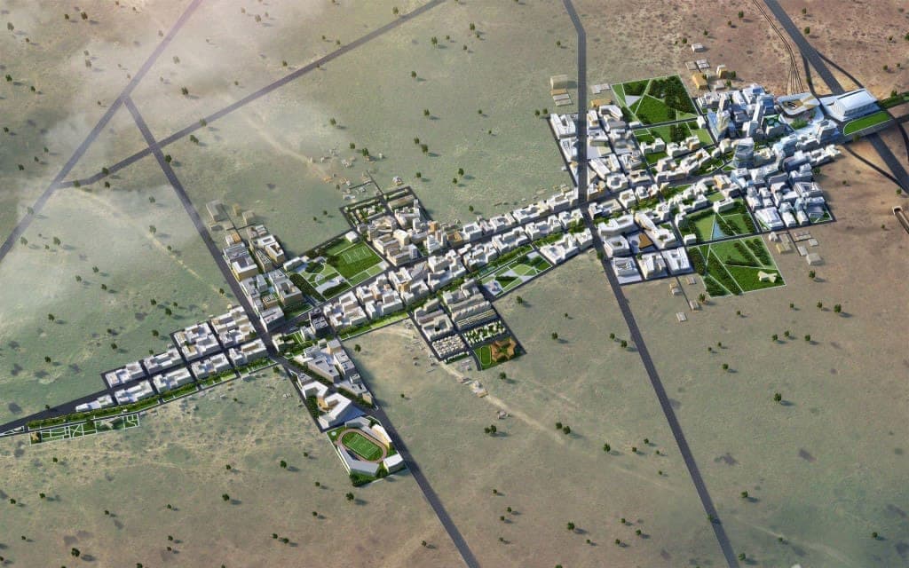 An aerial rendering of a planned town laid out along a desert road